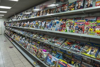 Shelf with magazines in a supermarket