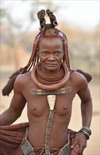 Portrait of a married Himba woman with necklace and headdress
