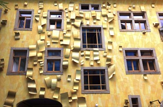 Yellow house facade with aluminium sheets