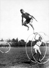 Man jumps over gymwheel