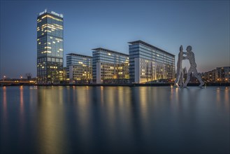 Treptowers and Molecule Men monument in the river Spree during blue hour