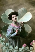 Woman in front of a four-leaf clover