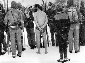 Naked man between skiers ca. 1970s