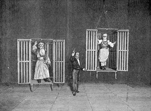 The illusionist Thorn demonstrates the appearance and disappearance of persons in cages