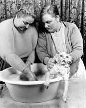 Two women washing cat