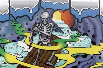 Human skeleton rows on a raft