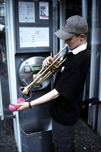 Trumpet player in the telephone booth