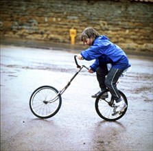 Child rides a bicycle from two parts
