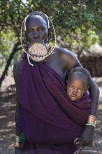 Woman with lip plate and baby