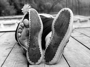 Toes peeking out of broken shoes ca. 1970s
