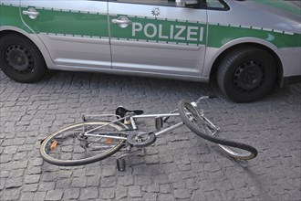 Bumped bicycle in front of a police car