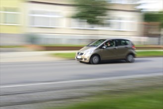 Car minivan drives through residential area
