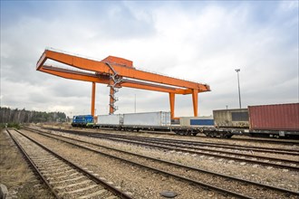 Cargo rail station with huge industrial overhead crane needed to railway transshipment
