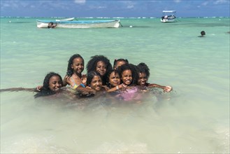 Local children bathing on the beach of Saint Francois