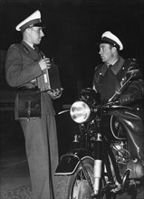 Police officer on motorcycle talking with a colleague