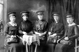 Women in uniform of an urban gasworks