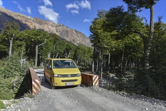 Yellow travel minibus on road to Lago del Desierto at Rio de las Vueltas