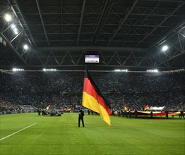 Atmospheric flag wavers with German flag in front of the start of the football match