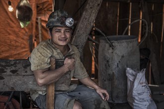 Native with headlamp on the illegal search for gold in mines