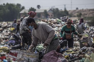 Garbage collectors on rubbish dump on the outskirts