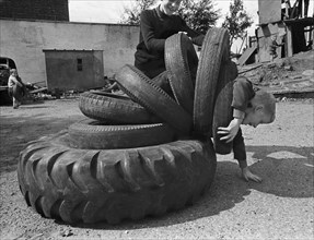 Child playing with tyres