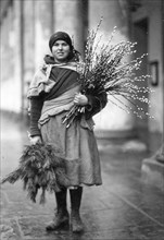 Woman with willow catkins and fir branches ca. 1930