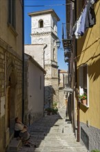 Narrow alley with bell tower of the Cathedral