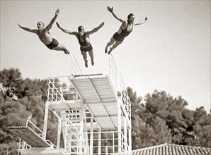 Three men jumping in a swimming pool