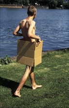 Naked man in a box