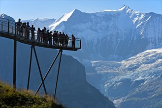 Tourists on the observation deck of the First Cliff Walk by Tissot in front of the Fiescherhorn north face and the Grindelwald glacier