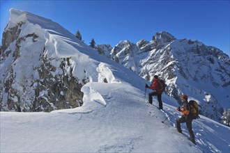 Two mountaineers on a ski tour in winter