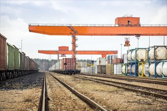 Cargo rail station with huge industrial overhead crane needed to railway transshipment