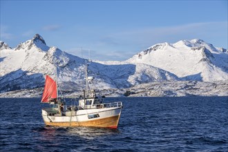 Traditional fishing boat catching the net