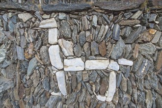 Llama figure in an old stone wall