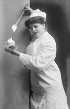 Female cook puts icing on the coffee