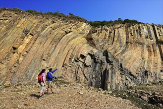 Hikers in front of Hexagonal Rock Columns in Geo Park