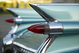 Tail fins with red tail lights of an american vintage car