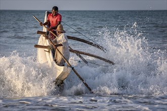 Fishermen breaking the waves at Kahandamodara beach