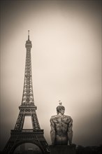 Eiffel tower and l'Homme (the Man) statue by artist Pierre Traverse