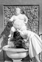 Woman drinking from a fountain