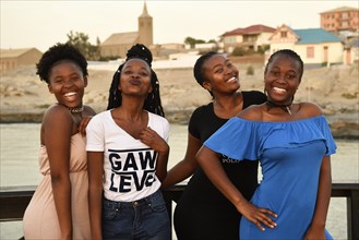 Four young black women posing at the Waterfront