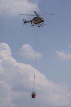 Helicopter with water tank for fire extinguishing