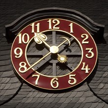 Clock on the slate roof of adult education center