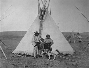 Indian Chief with his wife in front of their tent