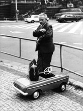 Man with toy car ca. 1970s
