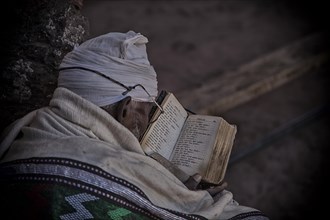 Coptic monk reads in book