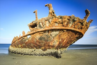 Rusty shipwreck on the beach