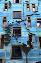Blue house facade with rain pipes