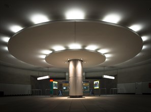 Illuminated column in entrance hall with ticket machine