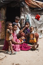 Women with small children in the slum at the Ghazipur garbage dump